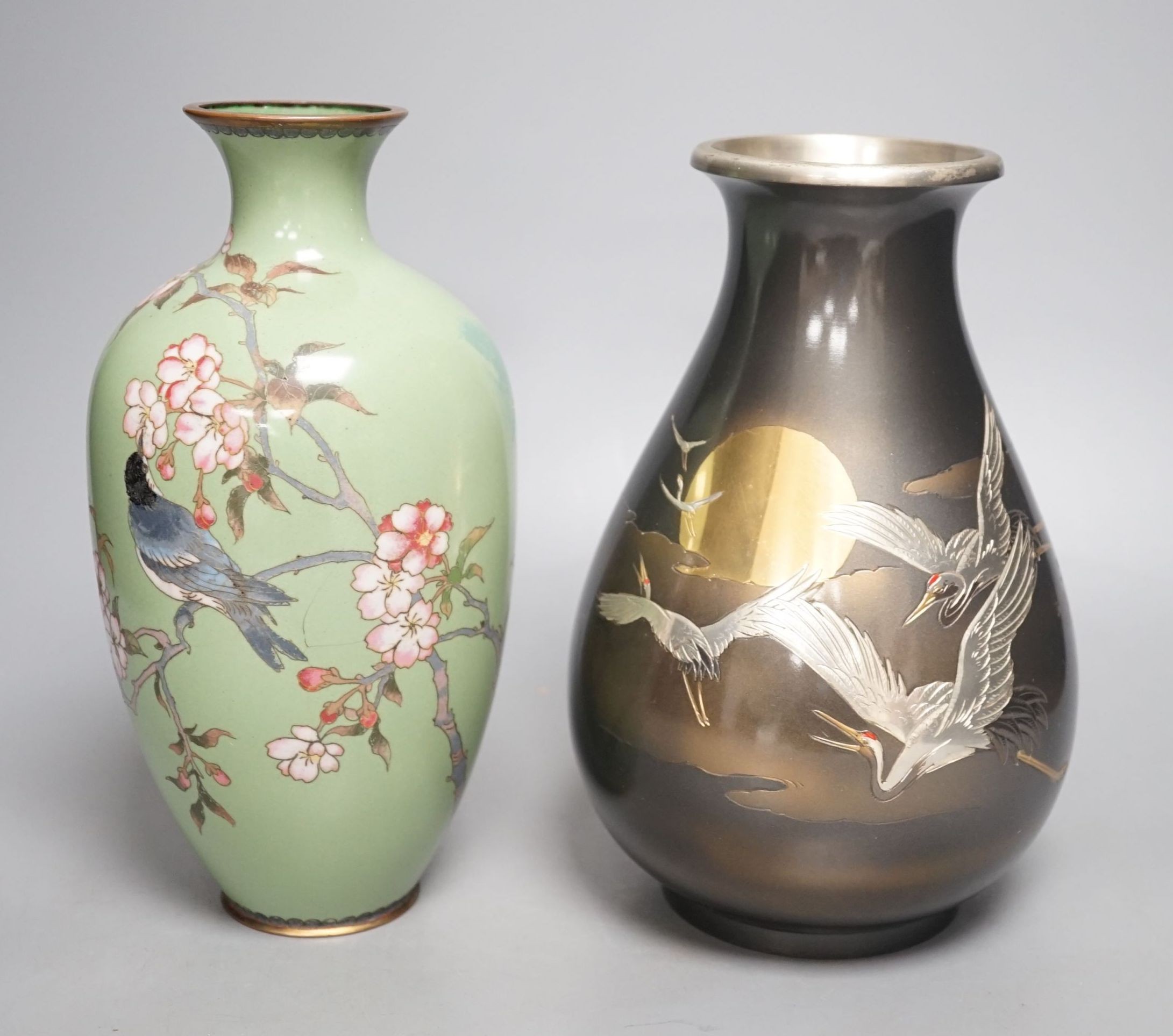 A Japanese cloisonné enamel vase and a Japanese mixed metal vase, cloisonné vase 25 cms high.